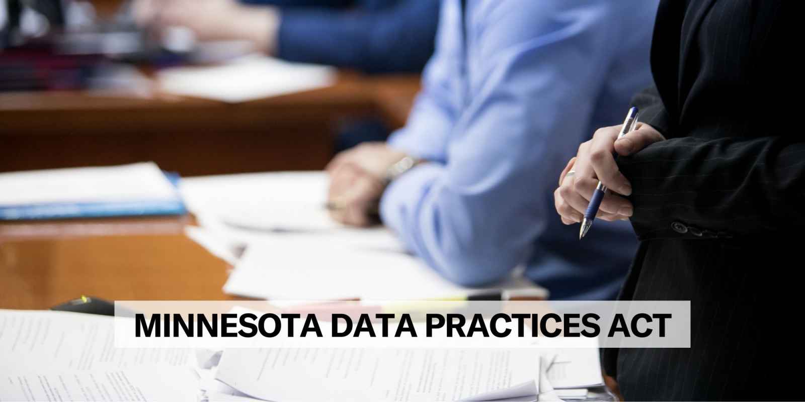 Photo of attorneys with papers. Text on the image says, "Minnesota data practices reform"