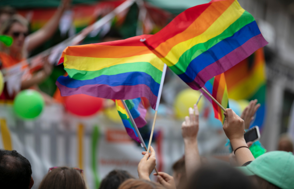 Photo of people waving Pride flags 