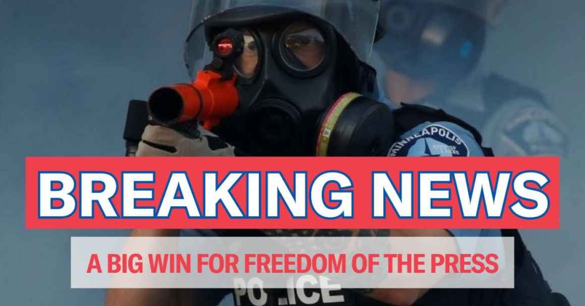 Photo of Minneapolis police officer in a gas mask pointing a weapon out with text over the photo that reads, "breaking news, a big win for freedom of the press"