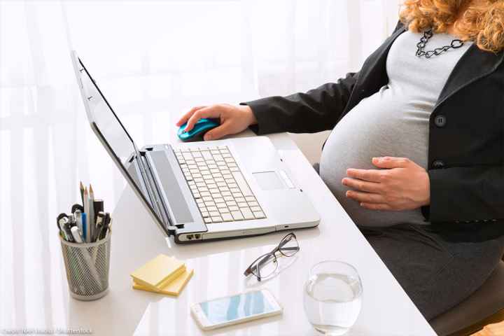 Pregnant woman working at the office