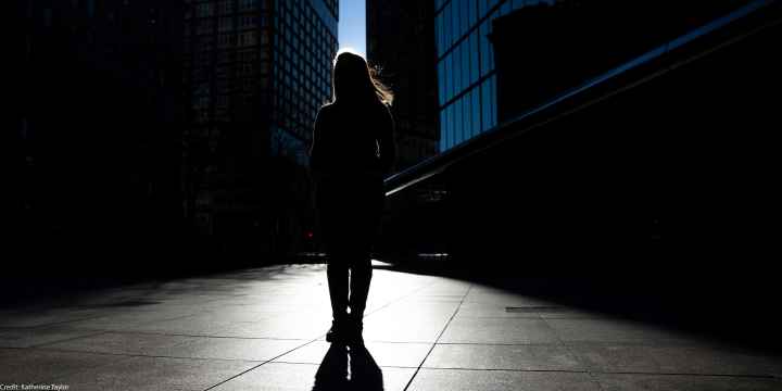 Silhouette of Farah, one of the woman in this blog, standing in front of skyscrapers