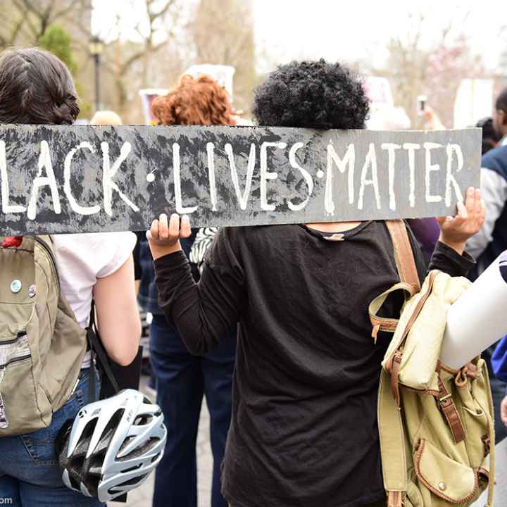 Protestors hold “Black Lives Matter” sign over their shoulders at a rally in Union Square before marching to Lower Manhattan.