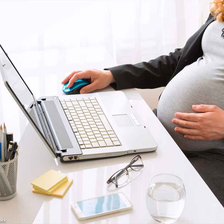 Pregnant woman working at the office