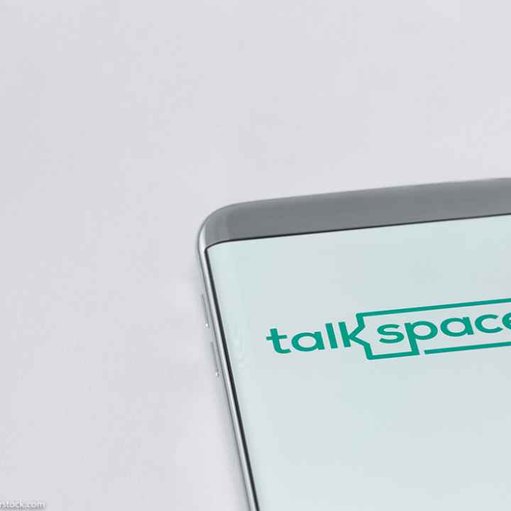 Image of Talkspace app on a smartphone on a white background.